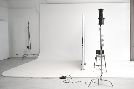 White studio with lights. Photo studio with white interior and lighting equipment, cyclorama.