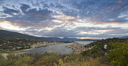 Girl admires the sunset  in Island Porosの写真素材