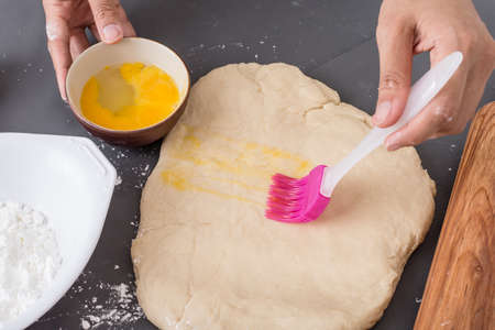 Female hands baking dough on the table