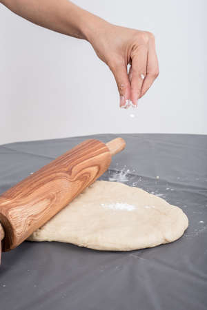 Female hands baking dough on the table