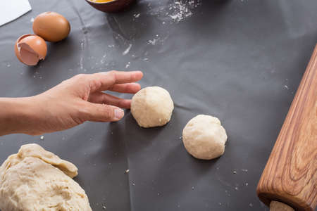 Female hands baking dough on the table