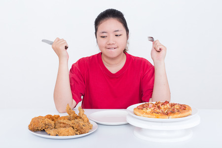 Woman with fast food - High calories food conceptの写真素材