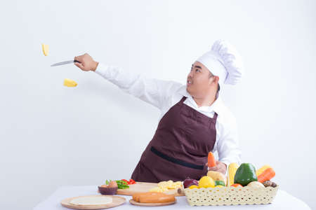 Chef cutting fresh vegetables in the air - on white backgroundの写真素材