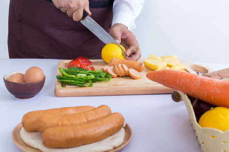 Close up chef hand cooking on white table