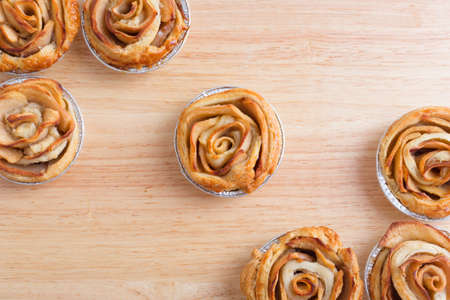 Mini apple rose pies - on wooden boardの写真素材