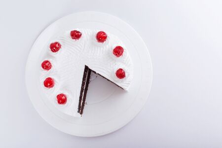 Chocolate cake with cherry on top - white backgroundの写真素材