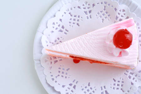 Strawberry cake with cherry on top - white backgroundの写真素材