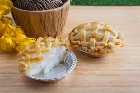 Mini coconut pies on wooden boardの写真素材
