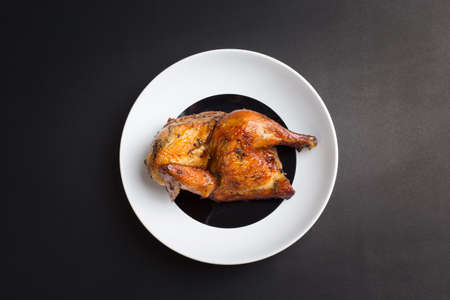 Roasted chicken on black backgroundの写真素材