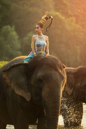 Thai Woman In Traditional Costume Of Thailand and elephant