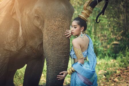 Thai Woman In Traditional Costume Of Thailand and elephantの写真素材