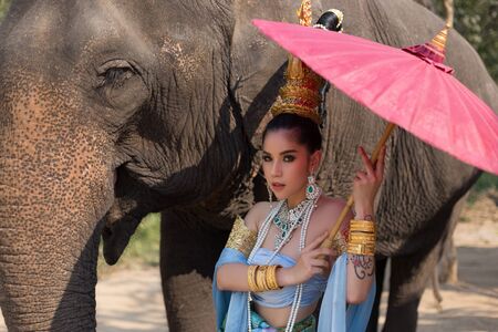 Thai Woman In Traditional Costume Of Thailand and elephantの写真素材