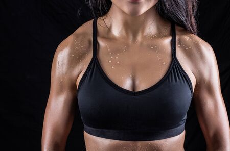 Beautiful body of fitness woman isolated on black backgroundの写真素材