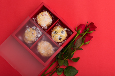 Red rose and cookies on red background - Valentine day or Wedding concept