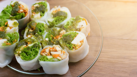 Fresh spring rolls with vegetable on wooden background