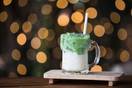 Glass of iced green tea on wooden table. - bokeh backgroundの写真素材