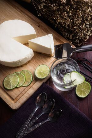 Ice box cheese cake with lemon and 
Lemon juice on wooden table. Homemade cheese cake.の写真素材