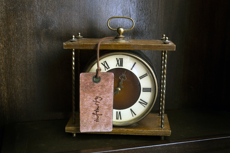 old watch and tag with the word infinityの写真素材