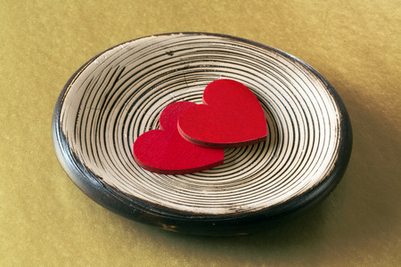 Two red hearts on a platterの写真素材