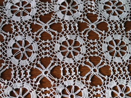 Patterned knitted a tablecloth on the wooden tableの写真素材