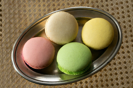 Multicolored cakes on a silver plateの写真素材