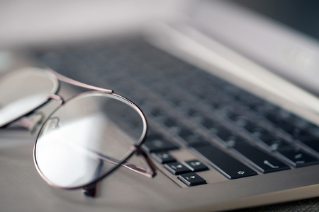 Glasses lying on the laptop keyboardの写真素材