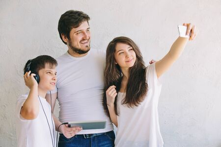 Family selfie in the Studio, with the background. The joy of being together.