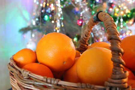 basket of oranges on the background of the Christmas tree. The smell of citrus  and Xmas trees - the traditions and symbols of the Soviet Union and Russiaの写真素材
