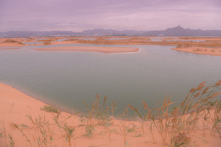Desert vastness next to lake in Wuhai, Inner Mongolia, China