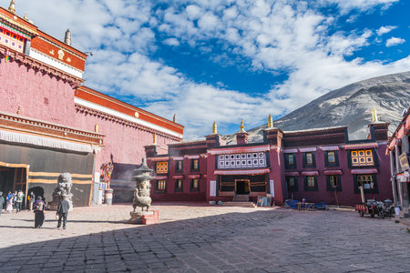 Explore the iconic red, gray, and white facade of Sakya Monastery in Tibet