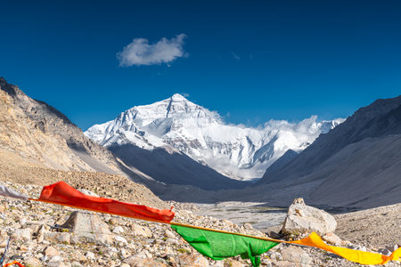 Prayer Flags blowing in the wind with Sun Flare blue sky in Tibet Chinaの写真素材