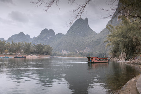 Dramatic sky over Guilin landscape and a river bend near Xingping, Chinaの写真素材
