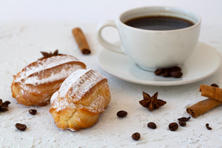 Traditional french tasty dessert. vanilla eclair on a plate on white background. Coffee cup with...