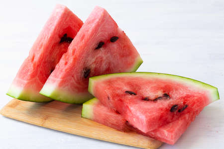 slice of watermelon.close-up ripe red watermelon on the white background. fresh watermelon on the...
