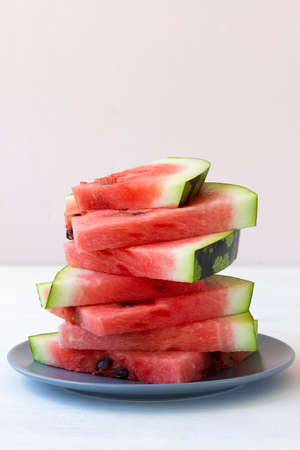 sliced watermelon on a plate.ripe red watermelon on the white background. fresh watermelon on the...