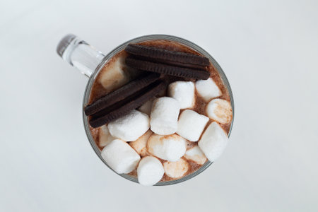 close-up Hot chocolate with marshmallow and cookies. Winter and autumn time. Christmas drink on the white background. copyspace. top viewの写真素材