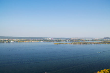 Autumn landscape. the autumn forest with yellowed leaves. Fall colors in the woods. view from the top of the mountain on the blue river.の写真素材