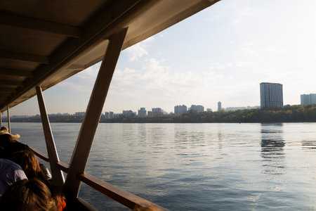 view from the boat. landscape of a big river with steep banks. clouds over the blue river. dawn over the lakeの写真素材