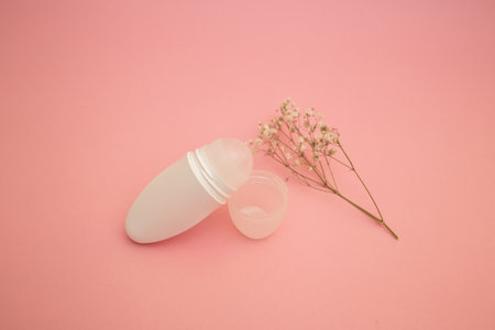 Roller deodorant antiperspirant on a pink background