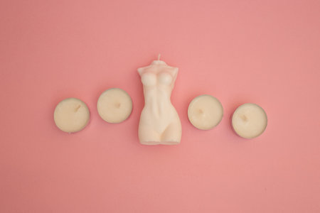 Candles with white wax on a pink backgroundの写真素材