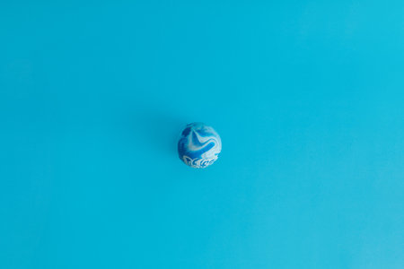 Blue ball in stains on a blue background, monochrome