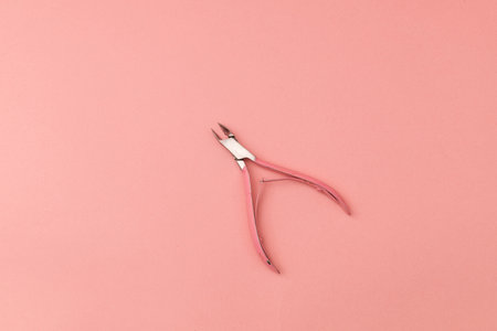 Tweezers for hands, pink on pink background - monochromeの写真素材