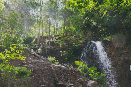 Waterfall in the mountains from a rocky cliffの写真素材