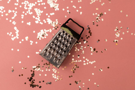 Vegetable and cheese grater on a pink festive backgroundの写真素材
