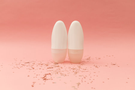 Roller deodorant in a white bottle on a pink backgroundの写真素材