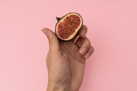 Cut juicy figs on a pink backgroundの写真素材