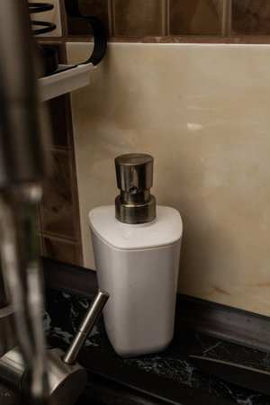 Dirty dishes in the sink with water and a washcloth, cleaning up after mealsの写真素材