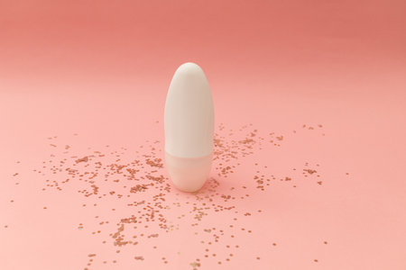 Roller deodorant in a white bottle on a pink backgroundの写真素材