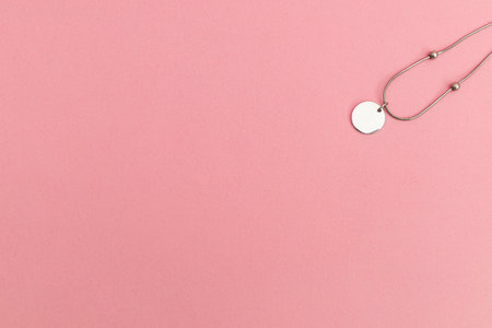 Silver jewelry on a pink backgroundの写真素材