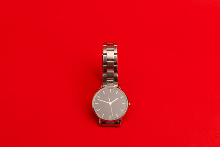 Silver watch on a bright red backgroundの写真素材
